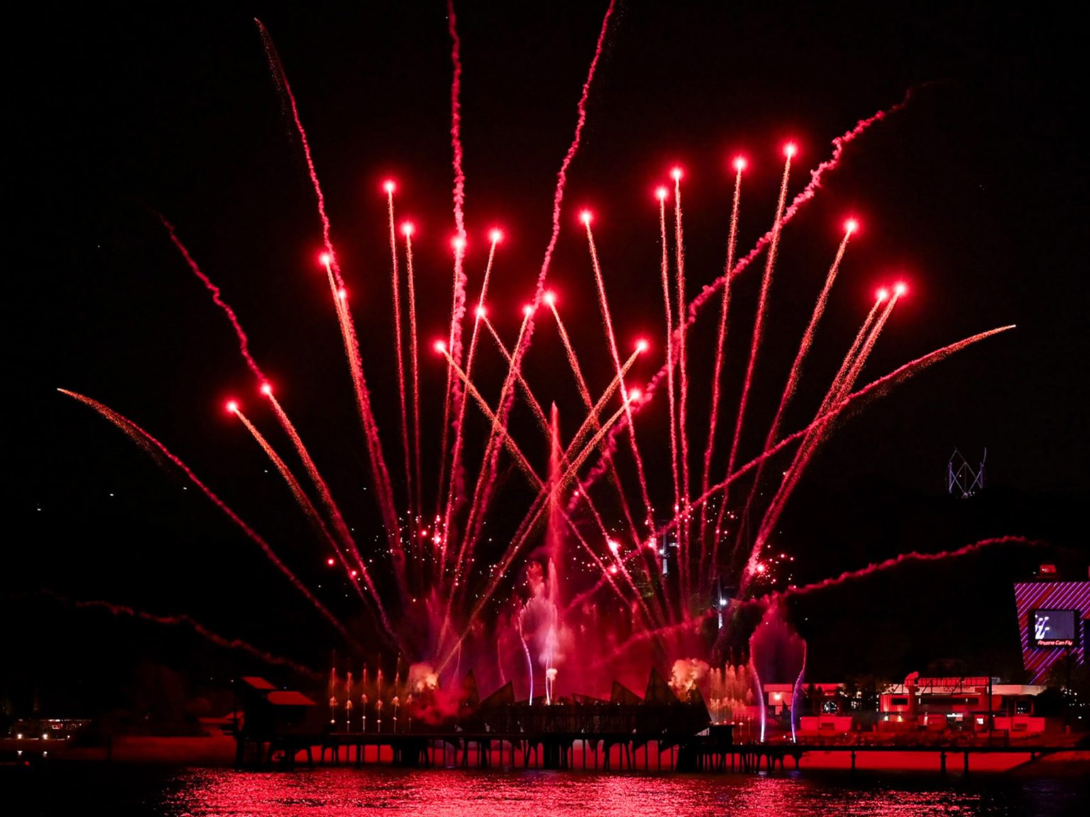 Red fireworks bursting over the water