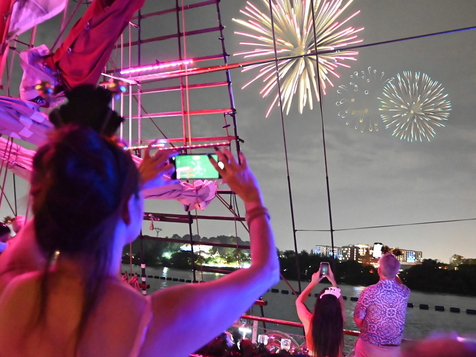 A guest filming the fireworks from the deck